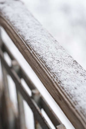 Snow lies on a wooden surfaceの写真素材