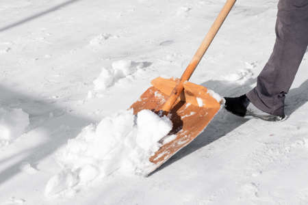 Snow removal with a special snow shovelの写真素材