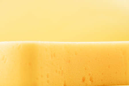 Yellow sponge on yellow backgroundの写真素材