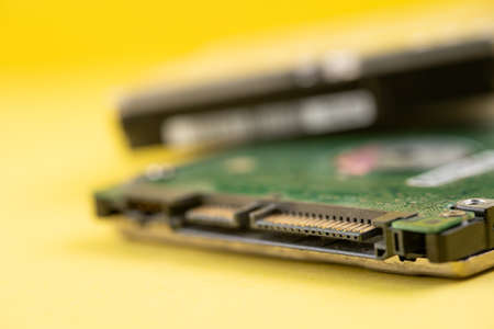 Hard disk on yellow backgroundの写真素材