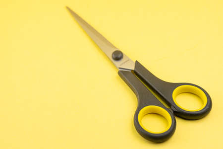 Household scissors on a yellow backgroundの写真素材