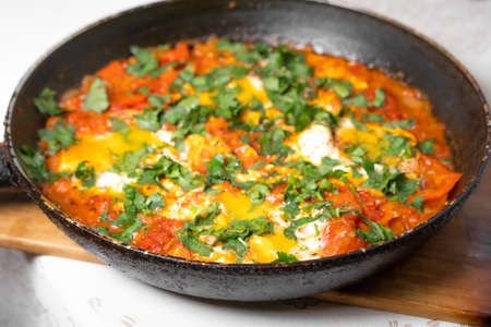 Scrambled eggs cooked in a metal frying panの写真素材