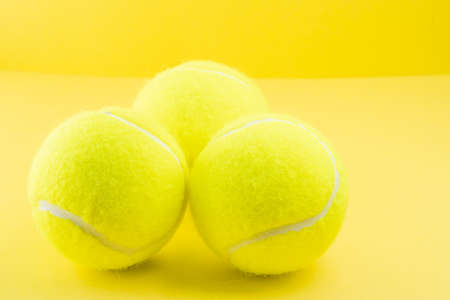 Tennis balls on yellow background