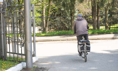 Aged man rides a bicycleの写真素材