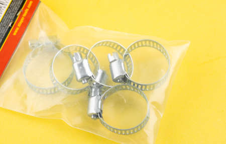 Construction metal clamps on a yellow backgroundの写真素材