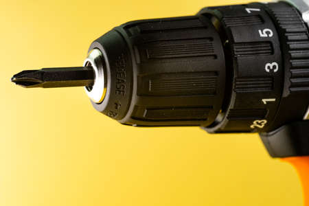 Drill driver on yellow backgroundの写真素材