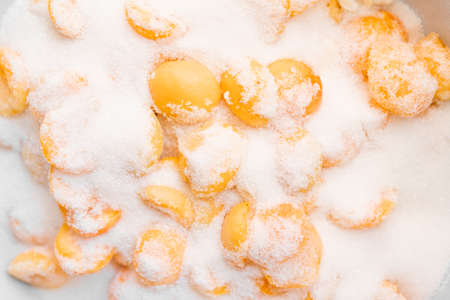 Ripe apricots in sugar for making jamの写真素材