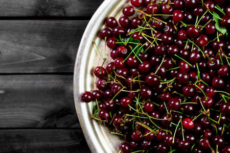 Ripe cherries on wooden backgroundの写真素材