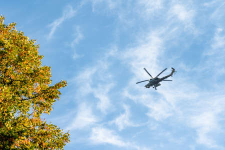 Combat helicopter flying across the skyの写真素材