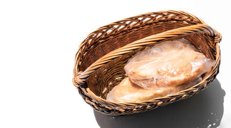 Basket with bread on a white backgroundの写真素材