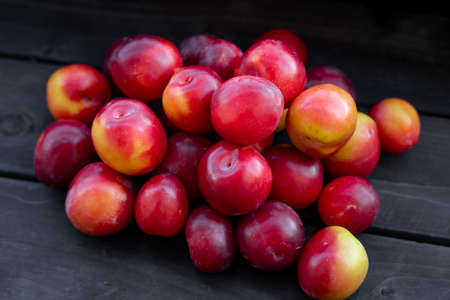 Ripe cherry plum on a black backgroundの写真素材
