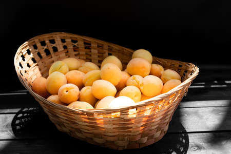Ripe apricots on a wooden backgroundの写真素材