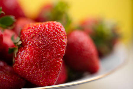 Ripe strawberry is in a plateの写真素材