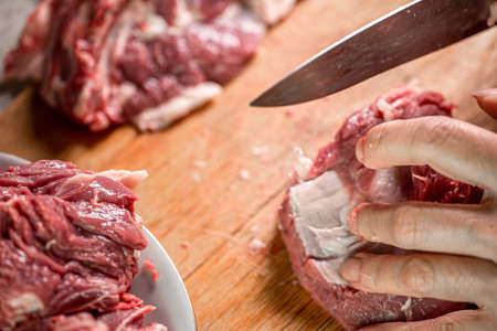 Butchering meat on a cutting boardの写真素材