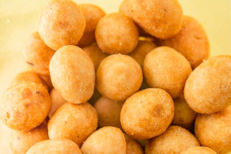Peanuts in glaze on yellow backgroundの写真素材