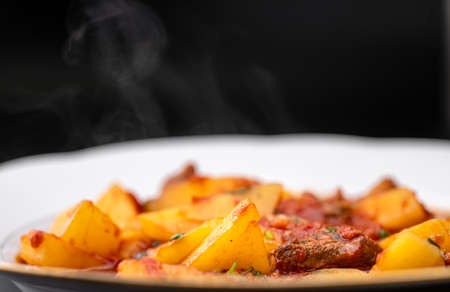 Hot sauce with meat in a plateの写真素材