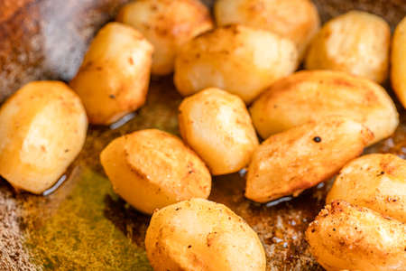 Whole fried potatoes in oilの写真素材