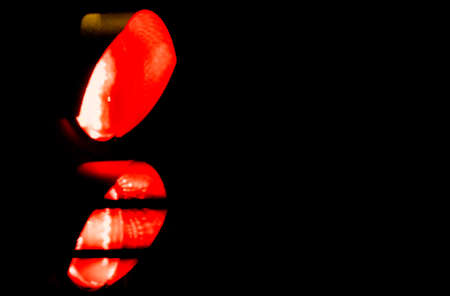 Red light at a traffic light at nightの写真素材