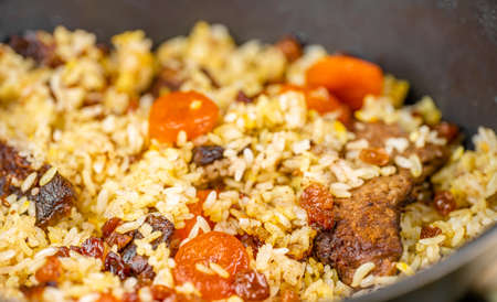 Pilaf with meat, dried apricots and raisinsの写真素材