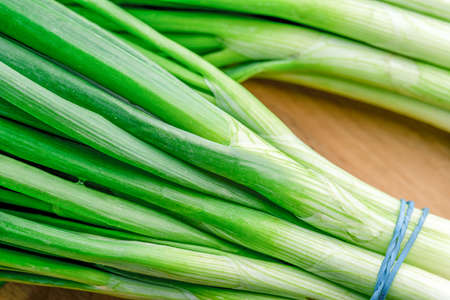 Green fresh onions on wooden backgroundの写真素材