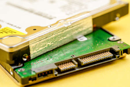 Hard disk on yellow backgroundの写真素材