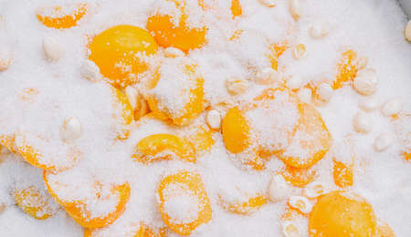 Making apricot jam. Apricots covered with sugarの写真素材
