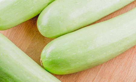 Ripe zucchini on wooden backgroundの写真素材