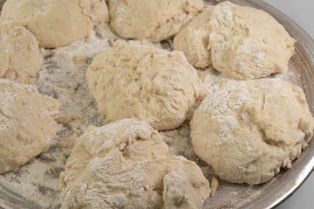 Dough in flour on a white backgroundの写真素材