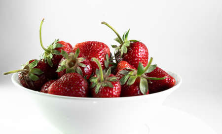 Strawberries in a plate on a white backgroundの写真素材