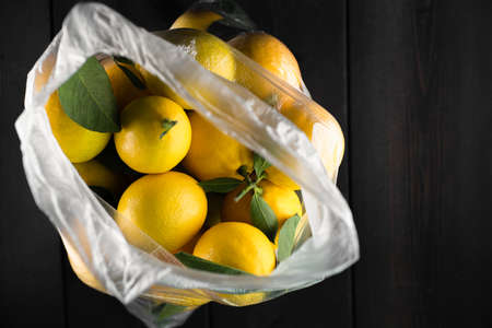 Ripe lemons on wooden backgroundの写真素材