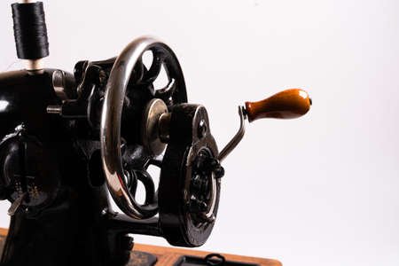 Old sewing machine on a white background