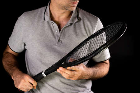 Tennis Man holding a racket for tennisの写真素材