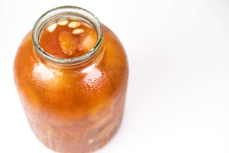 Jar with apricot jam isolated on white backgroundの写真素材