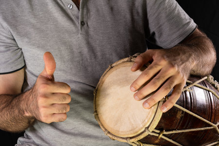 Man and hand drum. Thumb upの写真素材