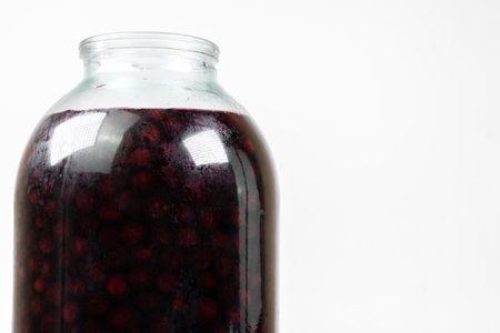 Jar with cherry jam isolated on white backgroundの写真素材