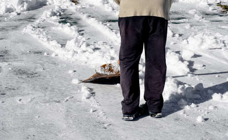 Man removing snow with a shovelの写真素材