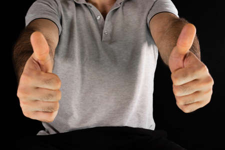A man shows a thumbs up as a sign that everything is fineの写真素材