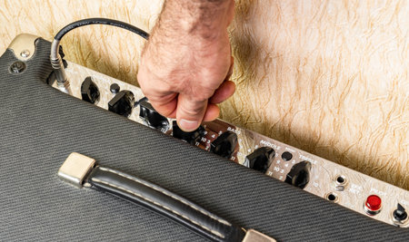 Turning the effects knob on the combo ampの写真素材