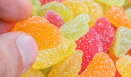 Multi-colored marmalade. Marmalade in the hands of a personの写真素材