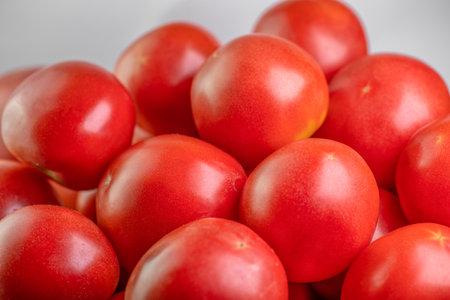 Ripe red tomatoes on white backgroundの写真素材