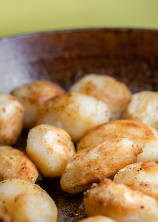 Pan-fried whole potatoes with peppersの写真素材