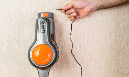 Charging the cordless vacuum cleanerの写真素材