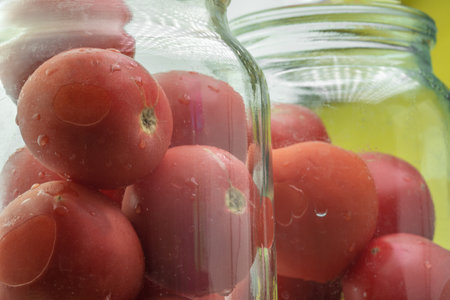 Cooking pickled tomatoes in a jarの写真素材