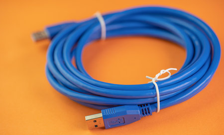USB connection cable on orange backgroundの写真素材