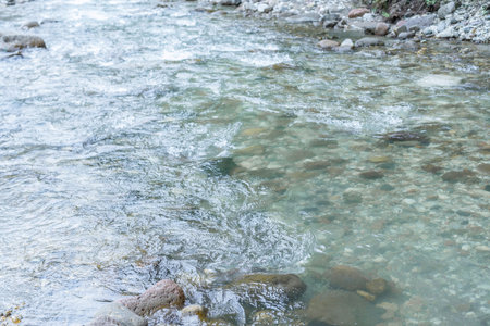 River flow in shallow waterの写真素材