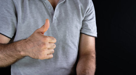 The man holds his thumb up as a sign that everything is fine.の写真素材