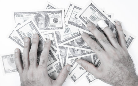 Many dollar bills and hands on themの写真素材
