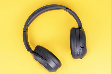 Full-size headphones on a yellow backgroundの写真素材