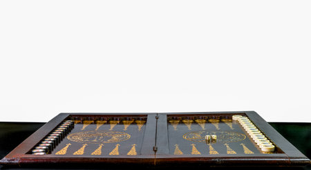A beautifully crafted wooden backgammon set is open and ready for play, featuring intricate designs and neatly organized pieces on a polished surface, inviting a game.の写真素材