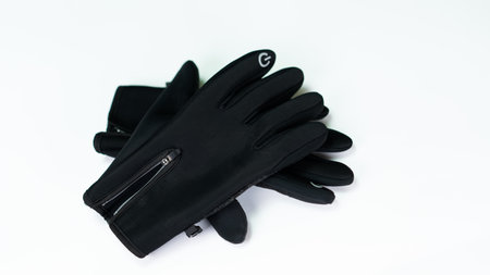 This image features a pair of sleek black gloves, designed for warmth and comfort during outdoor...